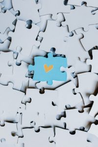 Image of a puzzle piece with a heart drawn on it